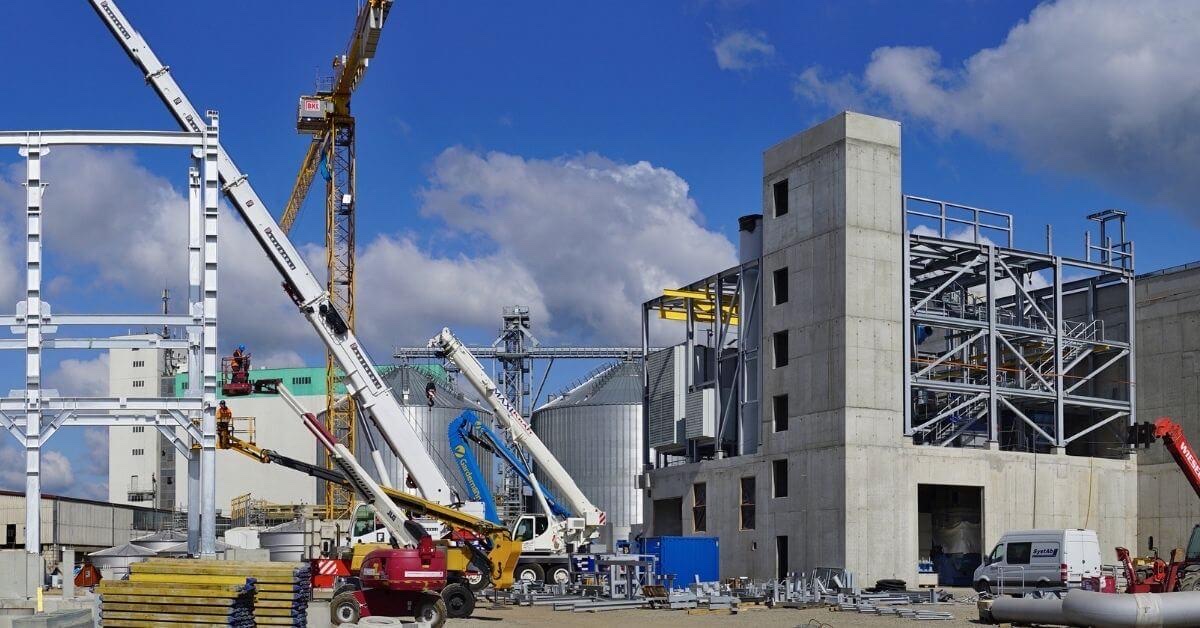 Cranes and a concrete tower on a large industrial construction site